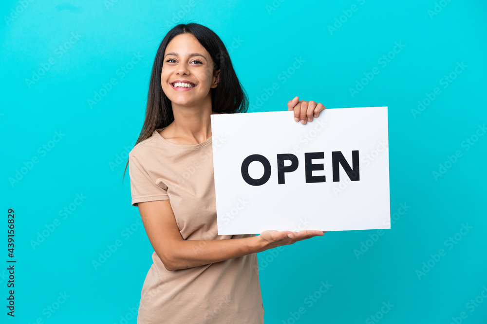 Young woman over isolated background holding a placard with peace symbol with happy expression Young woman over isolated background holding a placard with peace symbol with happy expression