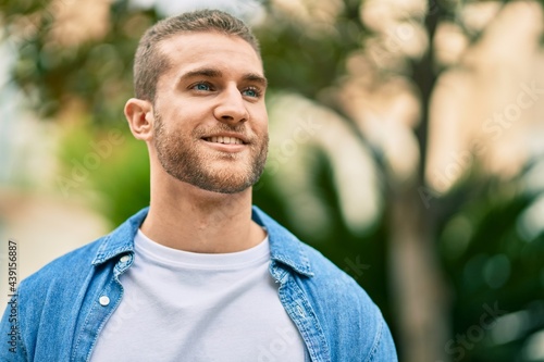 Young caucasian man smiling happy standing at the park.