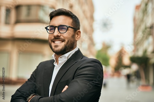 Young hispanic businessman with arms crossed smiling happy at the city. © Krakenimages.com