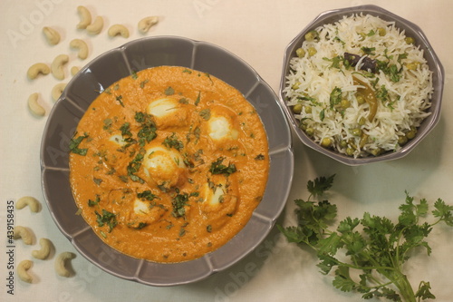 Egg butter masala and Green peas Pulav. A boiled egg dish with rich creamy gravy along with Green peas pulav photo