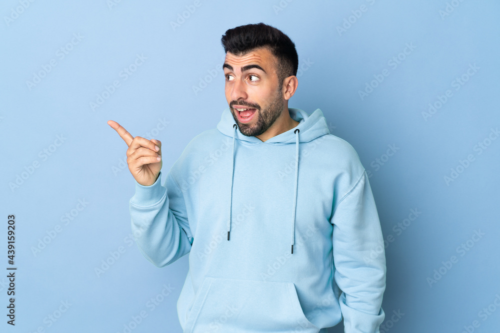 Caucasian man over isolated blue background intending to realizes the solution while lifting a finger up Caucasian man over isolated blue background intending to realizes the solution while lifting a finger up