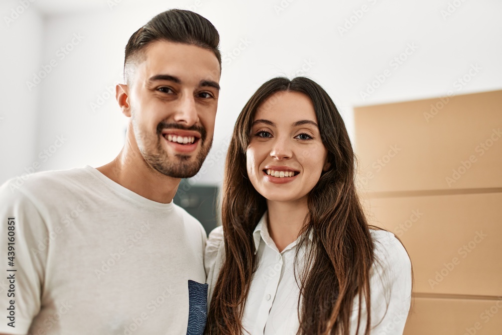 Young hispanic couple smiling happy and hugging at new home. Young hispanic couple smiling happy and hugging at new home.