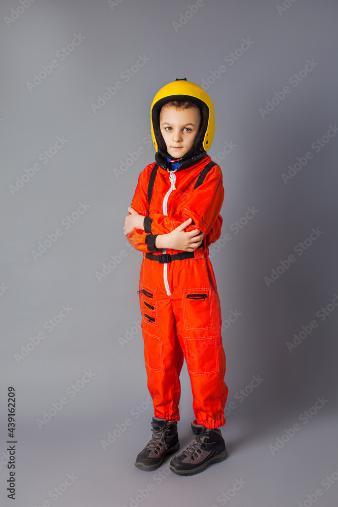 The little boy is posing in a parachute costume The little boy is posing in a parachute costume