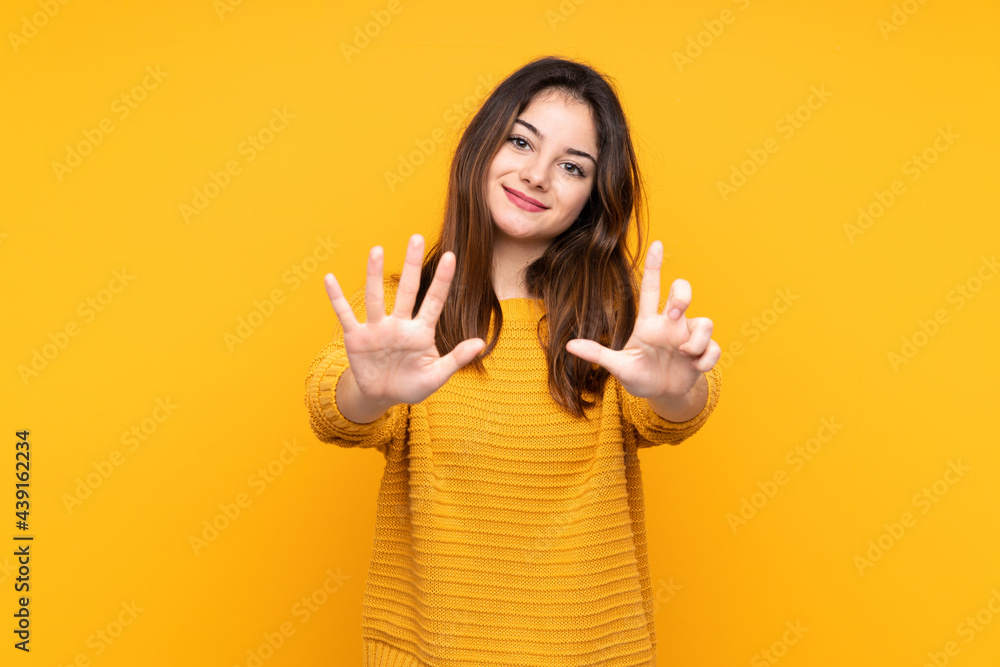 Young caucasian woman isolated on yellow background counting seven with fingers