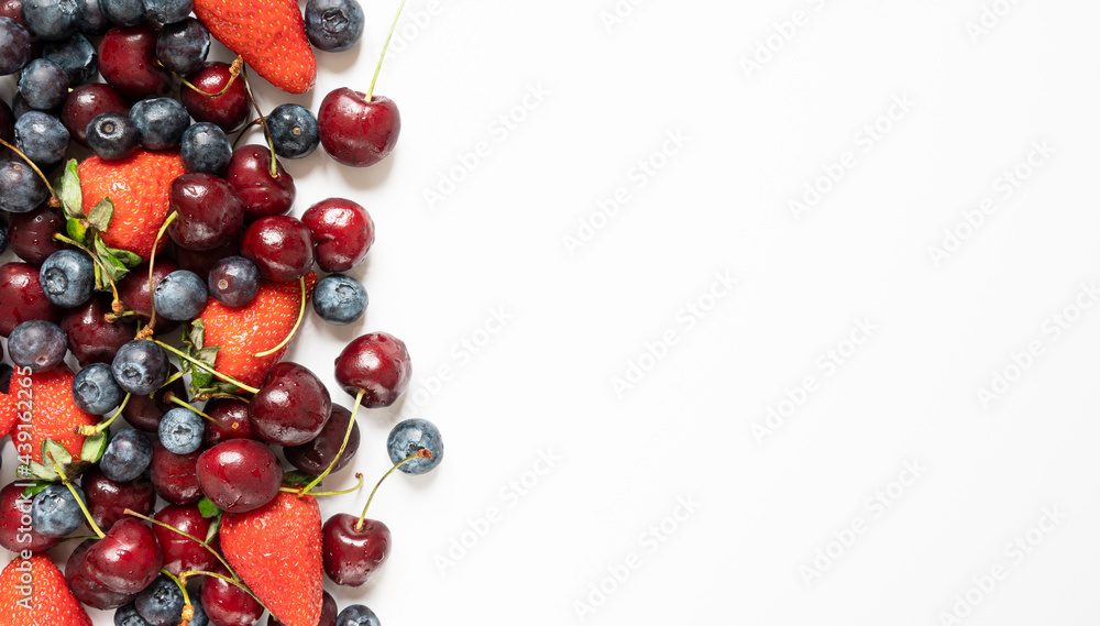 lots of strawberries, cherries and blueberries. juicy summer on white background with copy space lots of strawberries, cherries and blueberries. juicy summer on white background with copy space