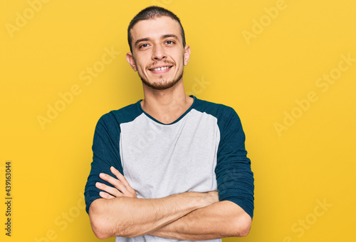 Hispanic young man wearing casual clothes happy face smiling with crossed arms looking at the camera. positive person.
