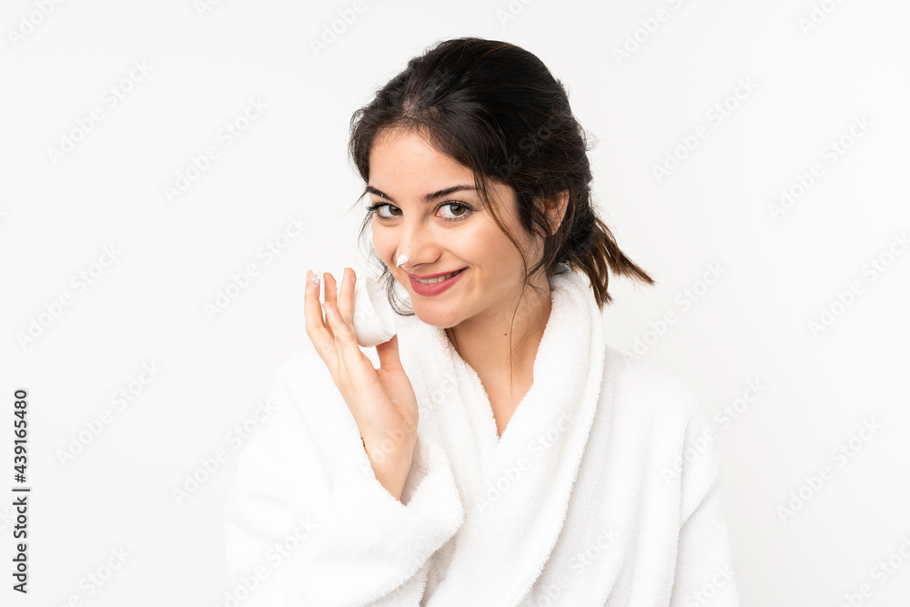 Young caucasian woman isolated on white background with moisturizer and smelling it Young caucasian woman isolated on white background with moisturizer and smelling it