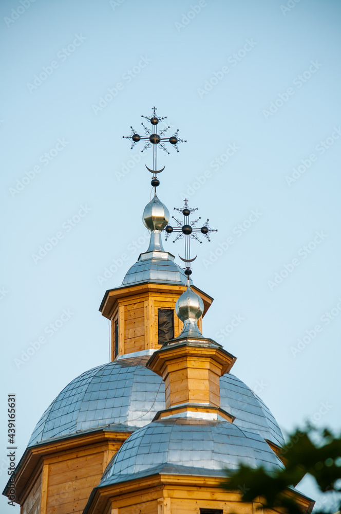 Golden Cross and the Dome of the Old Wooden Orthodox Church Against the Blue Sky. Close-up