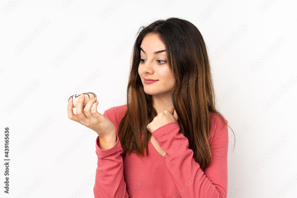 Young caucasian woman isolated on pink background holding a donut Young caucasian woman isolated on pink background holding a donut