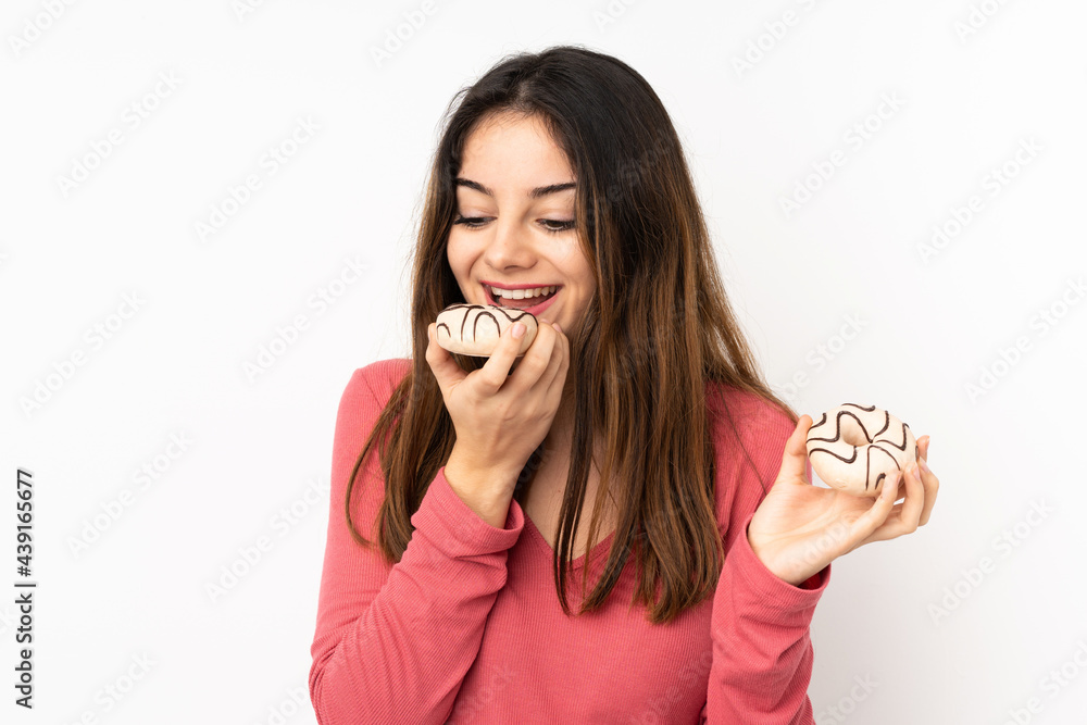 Young caucasian woman isolated on pink background holding a donut Young caucasian woman isolated on pink background holding a donut