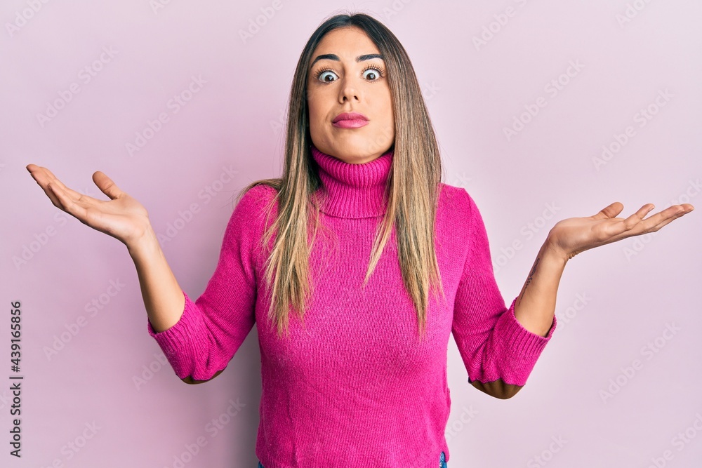 Young hispanic woman wearing casual clothes clueless and confused with open arms, no idea and doubtful face. Young hispanic woman wearing casual clothes clueless and confused with open arms, no idea and doubtful face.