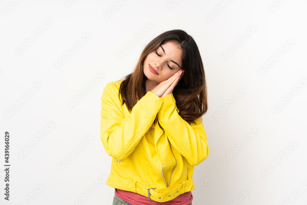 Young caucasian woman isolated on white background making sleep gesture in dorable expression Young caucasian woman isolated on white background making sleep gesture in dorable expression