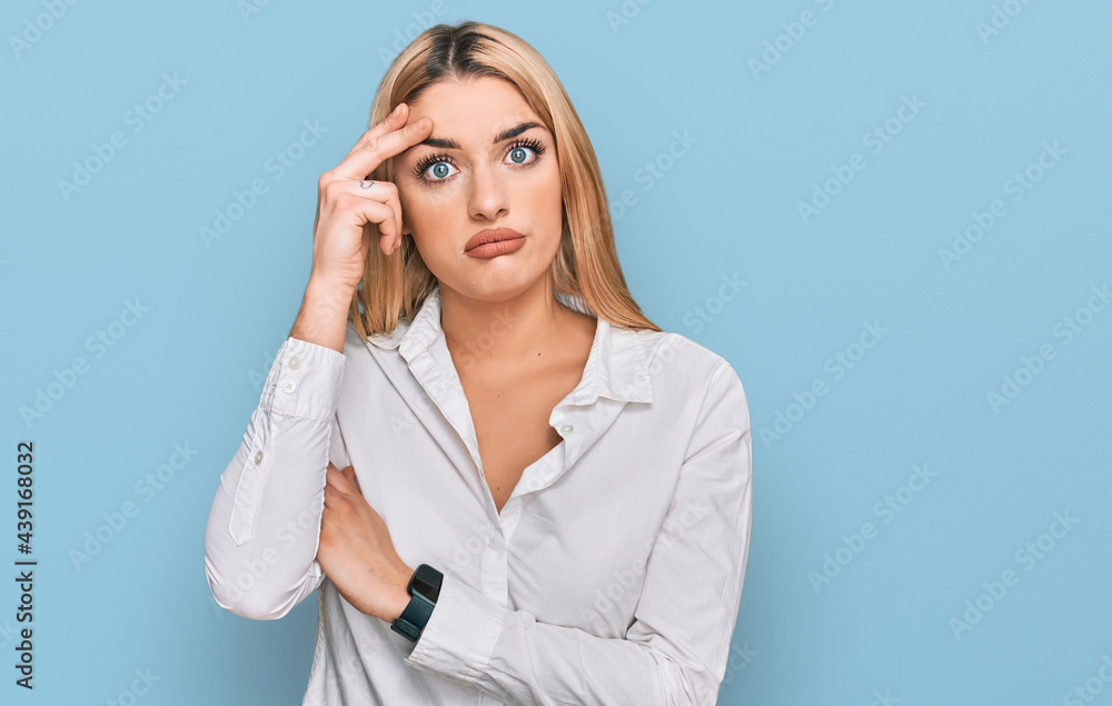 Young caucasian woman wearing casual clothes worried and stressed about a problem with hand on forehead, nervous and anxious for crisis Young caucasian woman wearing casual clothes worried and stressed about a problem with hand on forehead, nervous and anxious for crisis