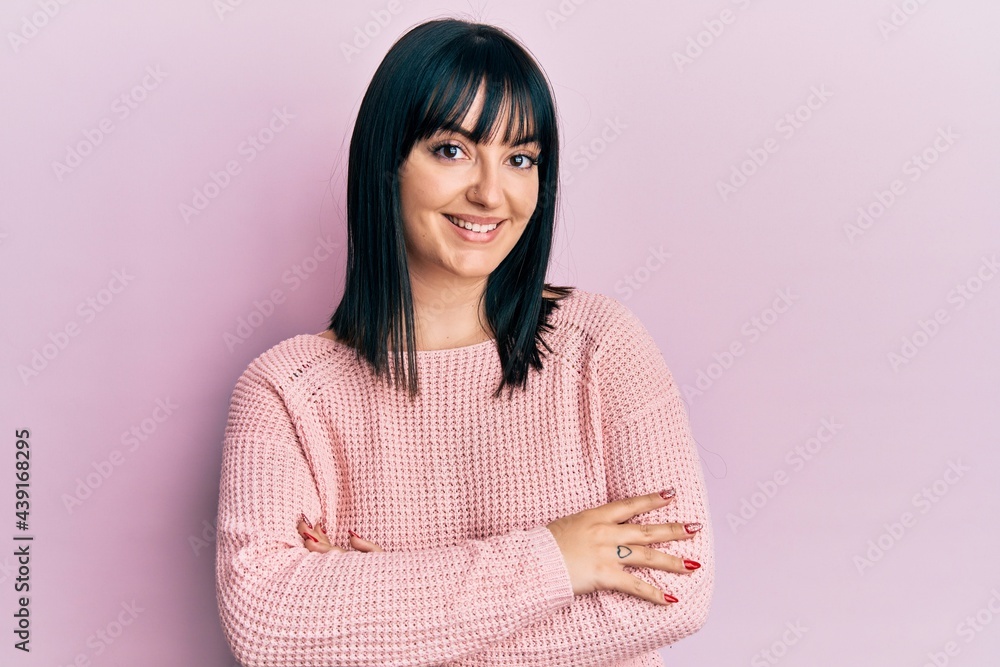 Young hispanic woman wearing casual clothes happy face smiling with crossed arms looking at the camera. positive person. Young hispanic woman wearing casual clothes happy face smiling with crossed arms looking at the camera. positive person.