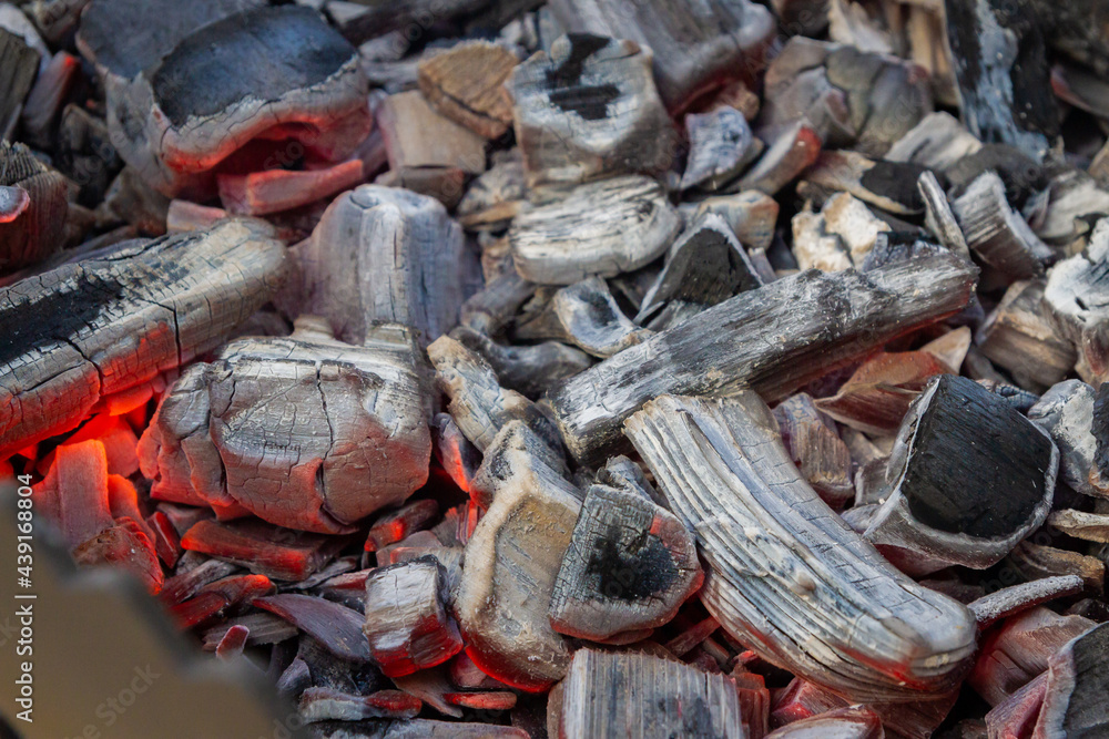 Red-hot coals lie in the barbecue grill in the spring