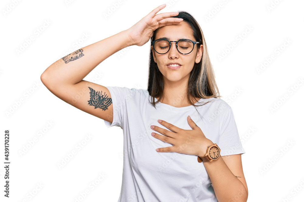 Young hispanic woman wearing casual white t shirt touching forehead for illness and fever, flu and cold, virus sick Young hispanic woman wearing casual white t shirt touching forehead for illness and fever, flu and cold, virus sick