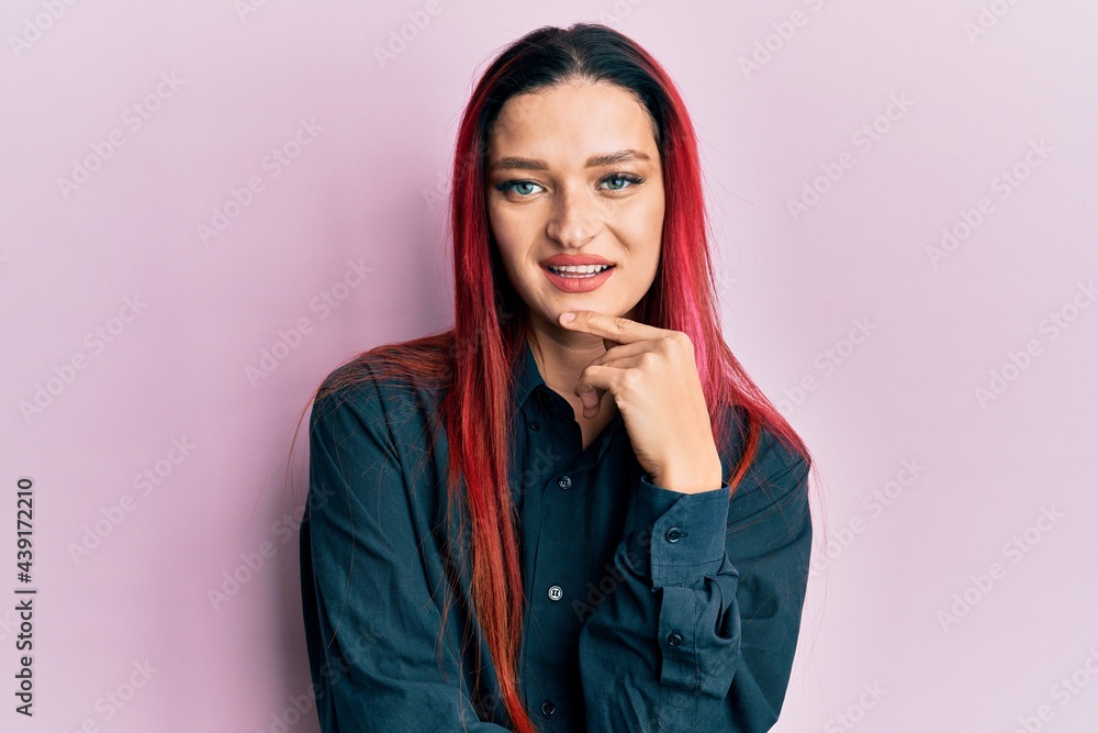 Young caucasian woman wearing casual clothes smiling looking confident at the camera with crossed arms and hand on chin. thinking positive. Young caucasian woman wearing casual clothes smiling looking confident at the camera with crossed arms and hand on chin. thinking positive.