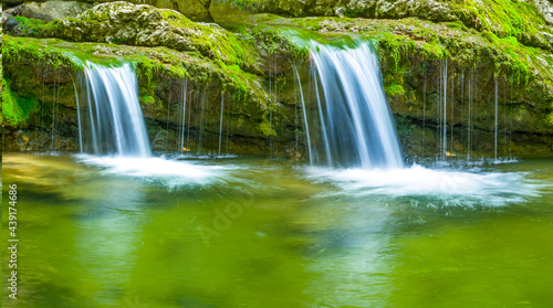 closeup small waterfall on mountain brook