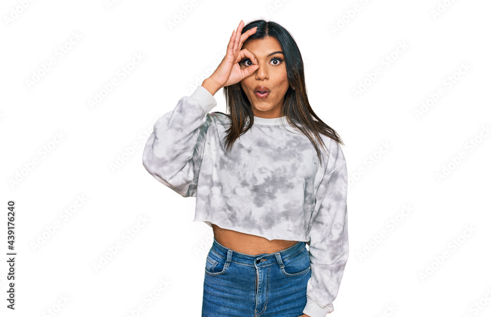 Young latin transsexual transgender woman wearing casual clothes doing ok gesture shocked with surprised face, eye looking through fingers. unbelieving expression. Young latin transsexual transgender woman wearing casual clothes doing ok gesture shocked with surprised face, eye looking through fingers. unbelieving expression.