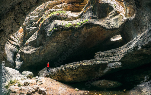A female silhouette in a huge cave. Saltinskij gorge in mountains landscape nature on Dagestan.