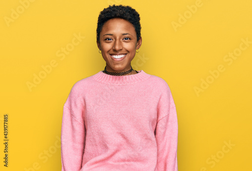 Young african american woman wearing casual clothes with a happy and cool smile on face. lucky person.