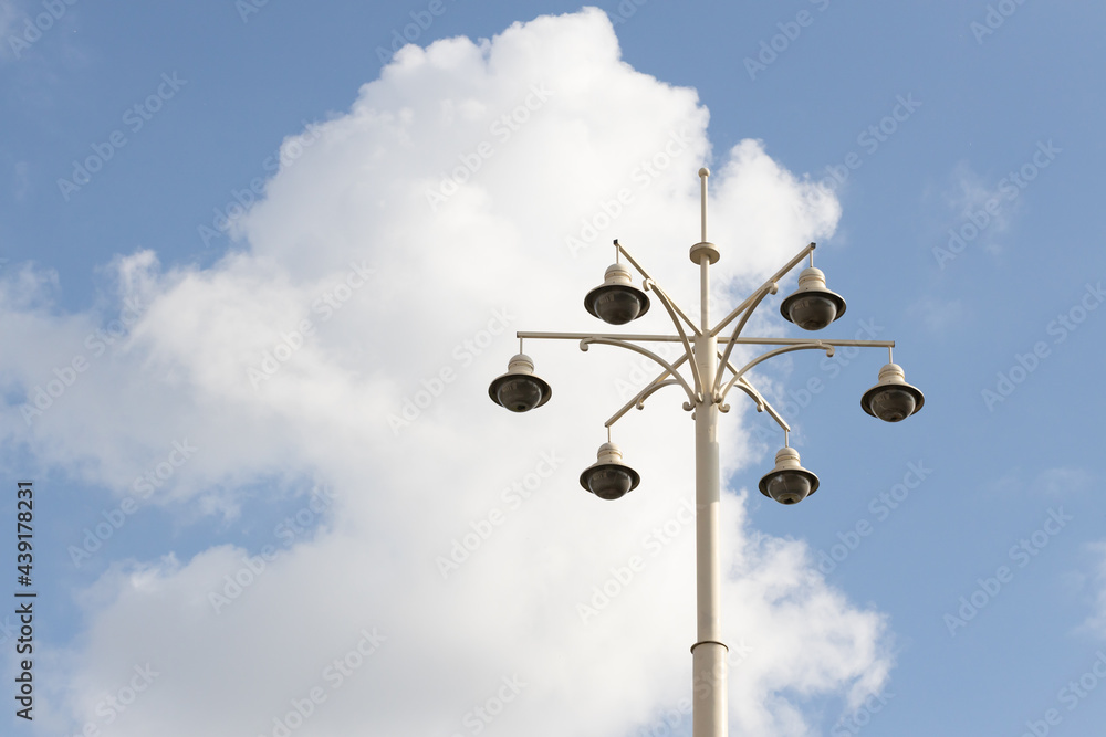 Street lamp with lamps in a classic style against a blue sky. High quality photo Street lamp with lamps in a classic style against a blue sky. High quality photo