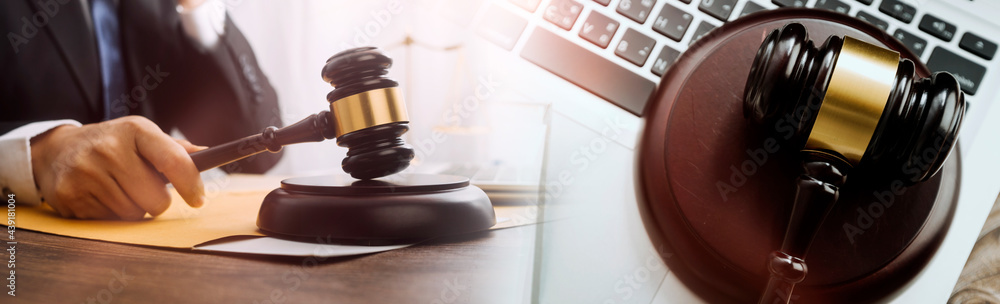 Business and lawyers discussing contract papers with brass scale on desk in office. Law, legal services, advice, justice and law concept picture with film grain effect Business and lawyers discussing contract papers with brass scale on desk in office. Law, legal services, advice, justice and law concept picture with film grain effect