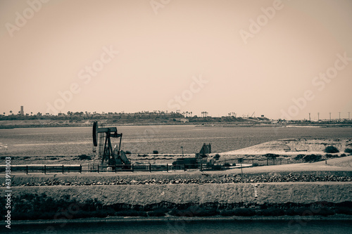 Vintage aged photo of oil field in Huntington beach California