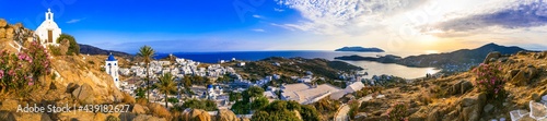 Fototapeta Naklejka Na Ścianę i Meble -  Breathtaking panoramic sunset view of Ios island. Chora town with churches and whitwashed houses. Popular tourist destination in Cyclades, Greece