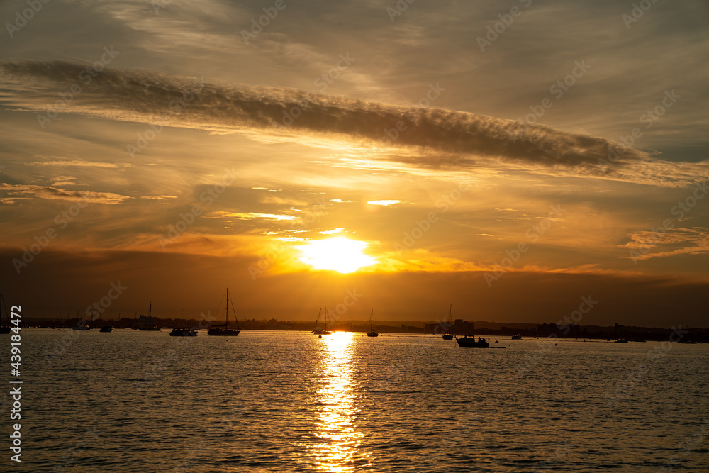 Sunset in cloudy day on Sandbanks beach United Kingdom looks beautiful ,sky was covered with nice golden colours