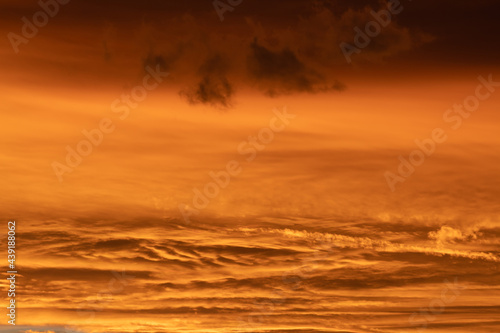 sunset with orange clouds in different shades in the sky