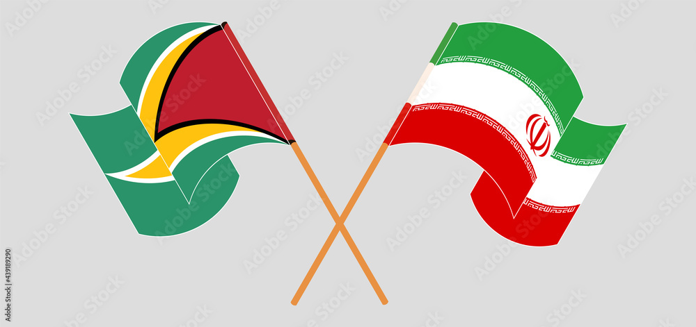 Crossed and waving flags of Guyana and Iran Crossed and waving flags of Guyana and Iran