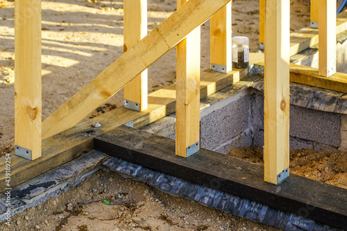 simple wooden frame building base construction, foundation waterproofing photo