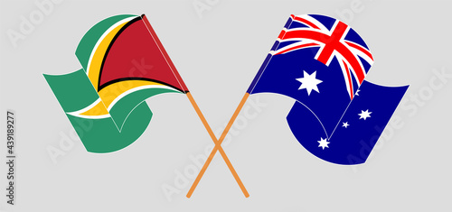Crossed and waving flags of Guyana and Australia