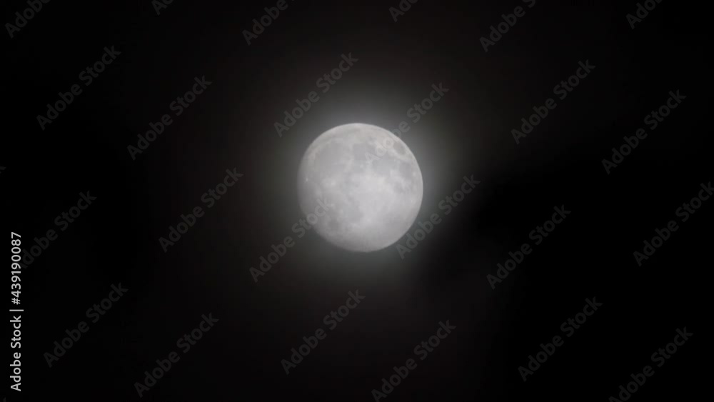 Full glowing mooon in cloudy night with slowly moving light clouds. Full glowing mooon in cloudy night with slowly moving light clouds.