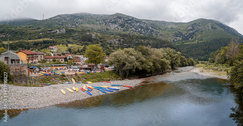 Vistas del río Deba a su paso por Unquera en Cantabria, con canoas de colores en su orilla, verano de 2020 photo