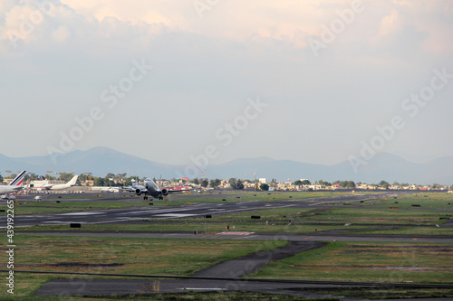 Plane taking off from the runway  flying through the clouds  increasing its height 