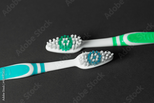 Toothbrushes on a dark background.