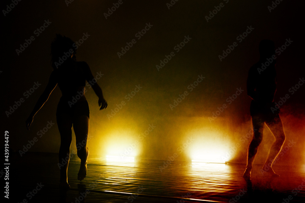 Young silhouette couple perform dancing moves Young silhouette couple perform dancing moves