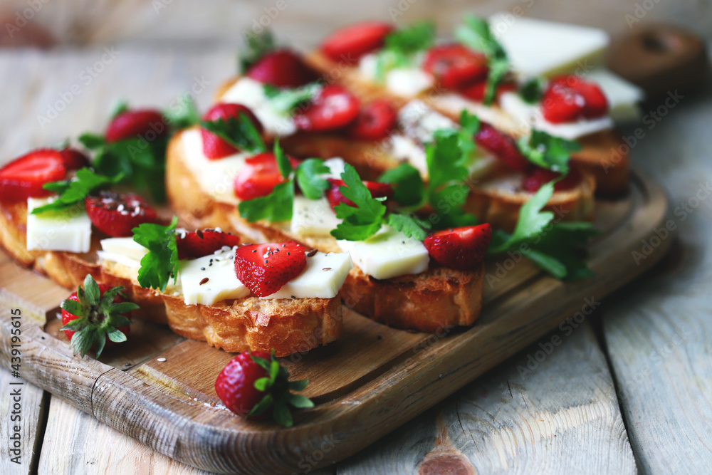 Beautiful strawberry toast with white cheese. Strawberry bruschetta. A healthy summer snack.