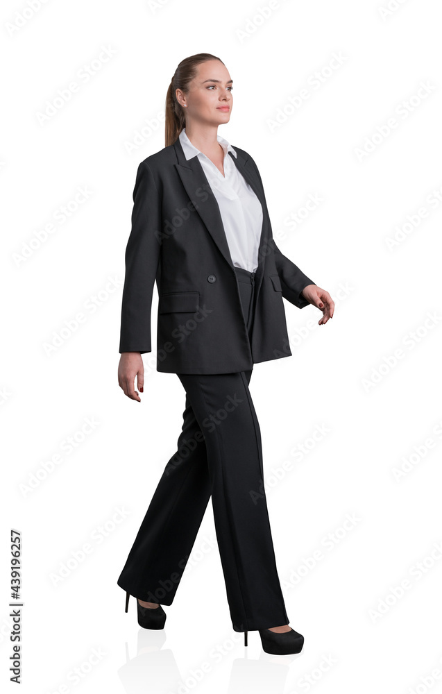 Side view of attractive full length business woman making step, businesswoman wear elegant black suit and high heels. Isolated over white background. The concept of hi-end consulting services. Side view of attractive full length business woman making step, businesswoman wear elegant black suit and high heels. Isolated over white background. The concept of hi-end consulting services.