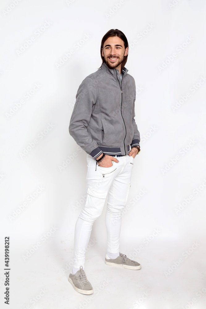 Attractive male model with long hair and beard posing in studio on isolated background. Style, trends, fashion concept. Attractive male model with long hair and beard posing in studio on isolated background. Style, trends, fashion concept.
