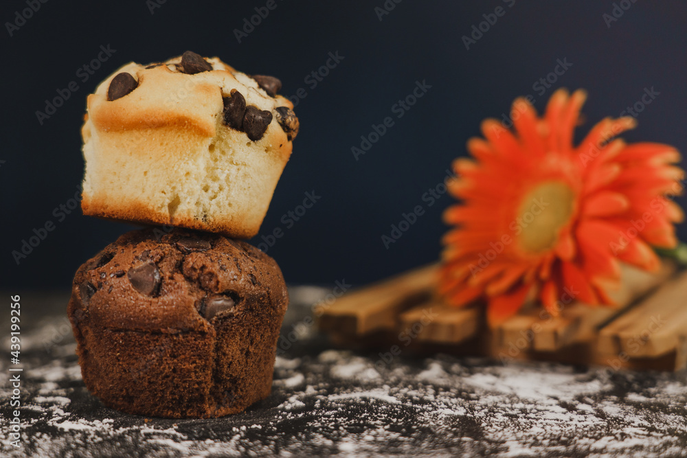 Homemade chocolate chips and vanilla muffin on a black background with sugar