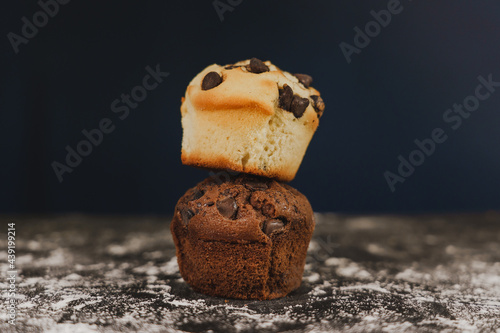 Homemade chocolate chips and vanilla muffin on a black background with sugar