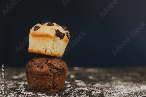 Homemade chocolate chips and vanilla muffin on a black background with sugar
