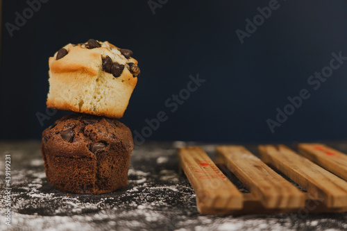 Homemade chocolate chips and vanilla muffin on a black background with sugar
