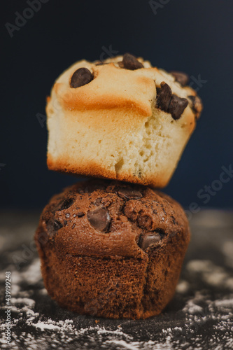 Homemade chocolate chips and vanilla muffin on a black background with sugar