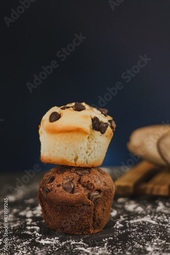 Homemade chocolate chips and vanilla muffin on a black background with sugar
