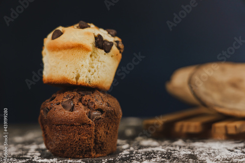 Homemade chocolate chips and vanilla muffin on a black background with sugar