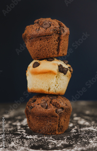 Homemade chocolate chips and vanilla muffin on a black background with sugar